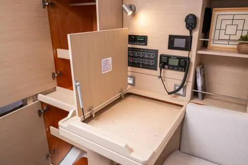 Slide: The Image of Navigation station in 2025 Beneteau Oceanis 37.1 yacht with control panels and storage. - 12