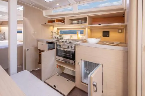 Slide: The Image of Modern kitchen interior of 2025 Beneteau Oceanis 37.1 yacht with light wood cabinetry. - 13