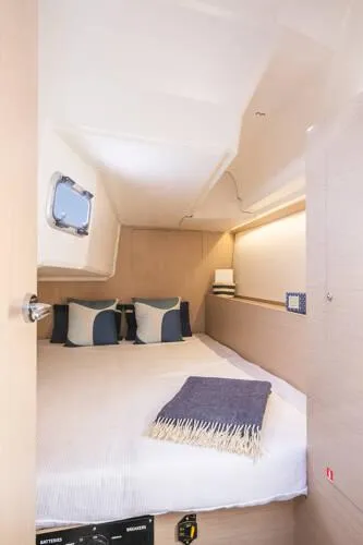 Slide: The Image of 2025 Beneteau Oceanis 37.1 cabin interior with cozy bed and nautical decor. - 15