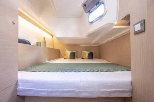 Slide: The Image of Cozy cabin interior of 2025 Beneteau Oceanis 37.1 yacht with modern bedding and decor. - 16