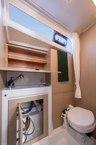 Slide: The Image of 2025 Beneteau Oceanis 37.1 yacht bathroom with modern fixtures and natural light. - 18