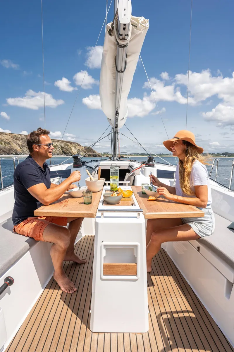 Slide: The Image of Couple dining on 2025 Beneteau Oceanis 37.1 sailboat under clear blue sky. - 5