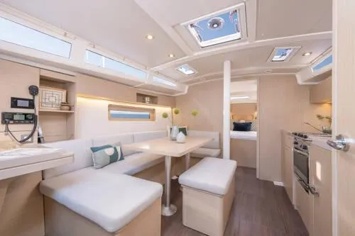 Slide: The Image of Interior of 2025 Beneteau Oceanis 37.1 yacht, featuring modern dining area and kitchen. - 8