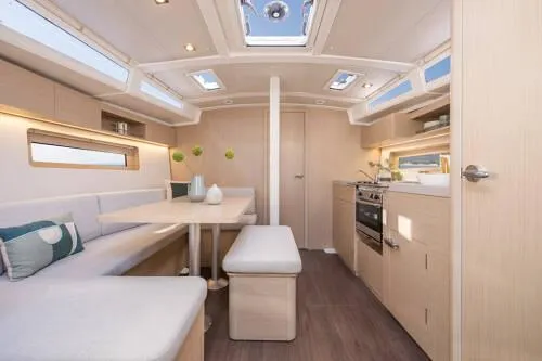 Slide: The Image of Interior of 2025 Beneteau Oceanis 37.1 yacht, featuring modern kitchen and dining area. - 9