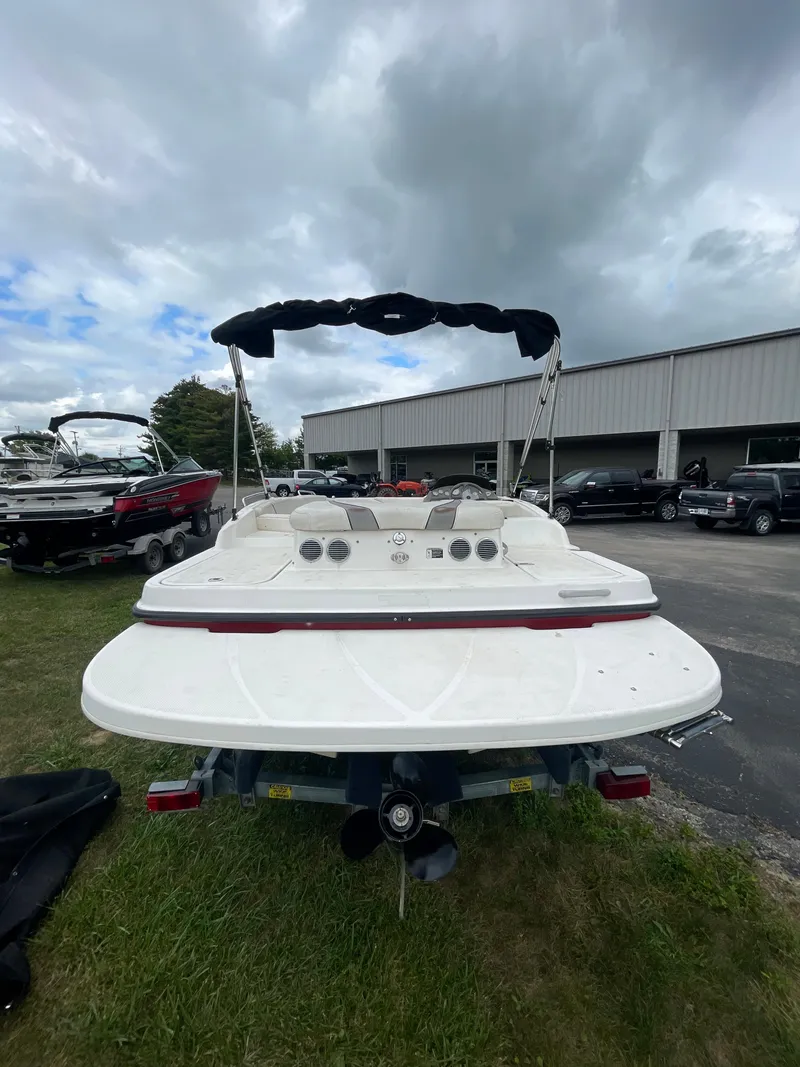 Slide: The Image of 2011 Bayliner 197 boat with canopy, parked outdoors. - 10