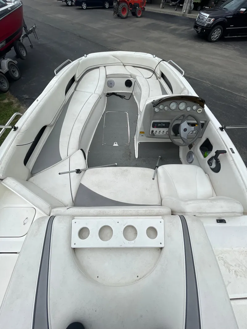 Slide: The Image of 2011 Bayliner 197 boat interior with white seating and control panel. - 12