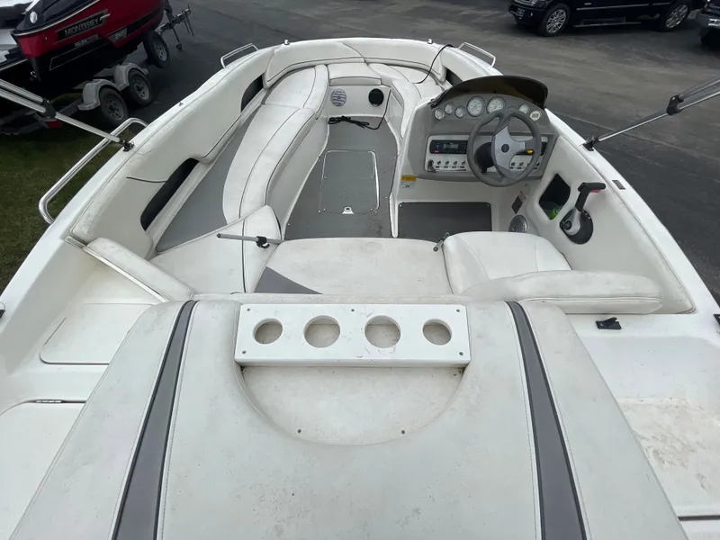 Slide: The Image of 2011 Bayliner 197 boat interior with white seating and dashboard. - 13