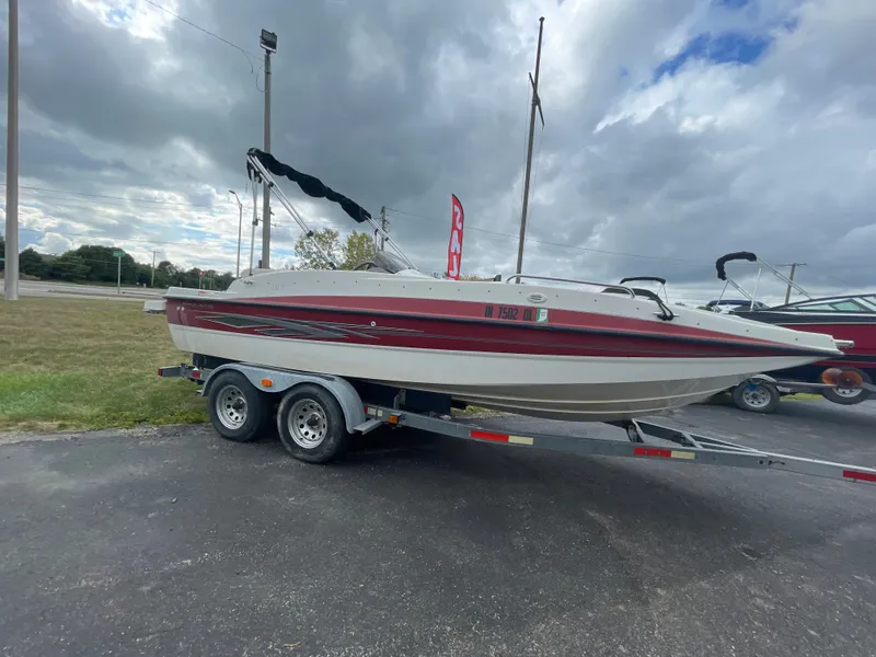 Slide: The Image of 2011 Bayliner 197 boat on a trailer under cloudy skies. - 7