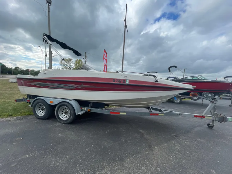 Slide: The Image of 2011 Bayliner 197 boat on a trailer under cloudy sky. - 8