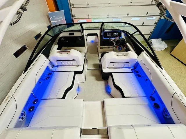 Slide: The Image of 2024 Regal LS2 boat interior with white seating and blue LED lighting. - 10