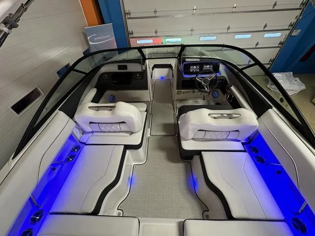 Slide: The Image of 2024 Regal LS2 boat interior with white seating and blue LED lighting. - 11