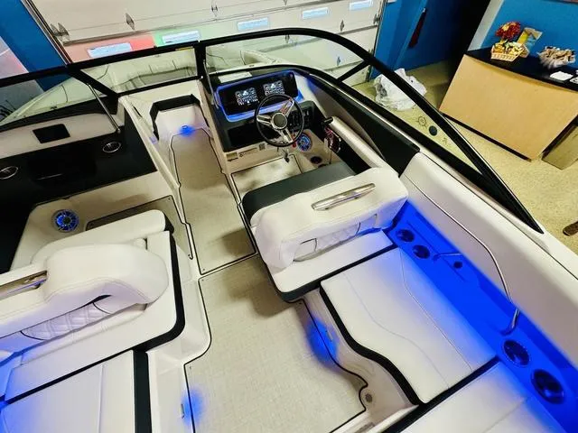 Slide: The Image of 2024 Regal LS2 boat interior with blue LED lighting and modern dashboard. - 12