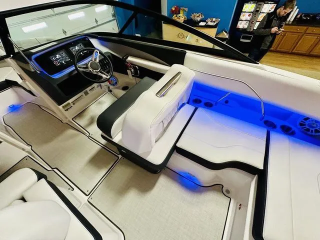 Slide: The Image of 2024 Regal LS2 boat interior with modern dashboard and blue LED lighting. - 13