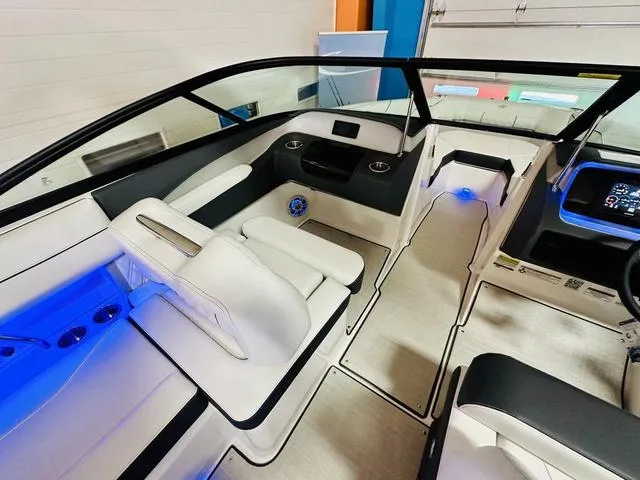 Slide: The Image of 2024 Regal LS2 boat interior with white seating and blue LED lighting. - 14