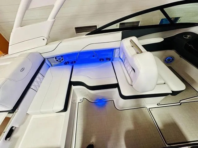 Slide: The Image of 2024 Regal LS2 boat interior with white seating and blue LED lighting. - 15
