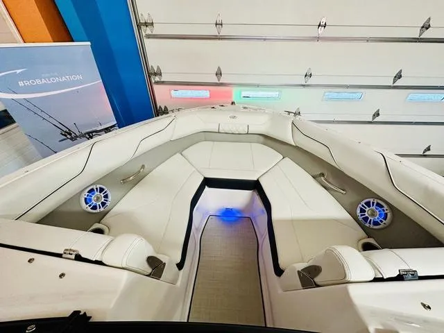 Slide: The Image of 2024 Regal LS2 boat interior with white seating and blue LED lighting. - 16