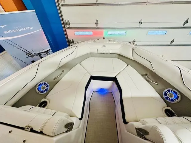 Slide: The Image of 2024 Regal LS2 boat interior with white seating and blue LED lighting. - 17