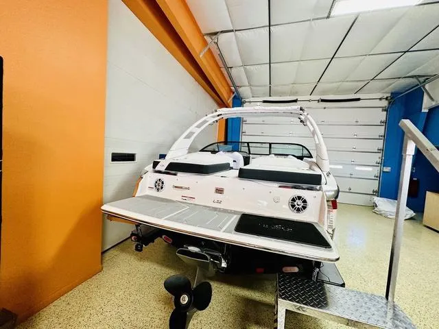 Slide: The Image of 2024 Regal LS2 boat in a garage with orange walls. - 4