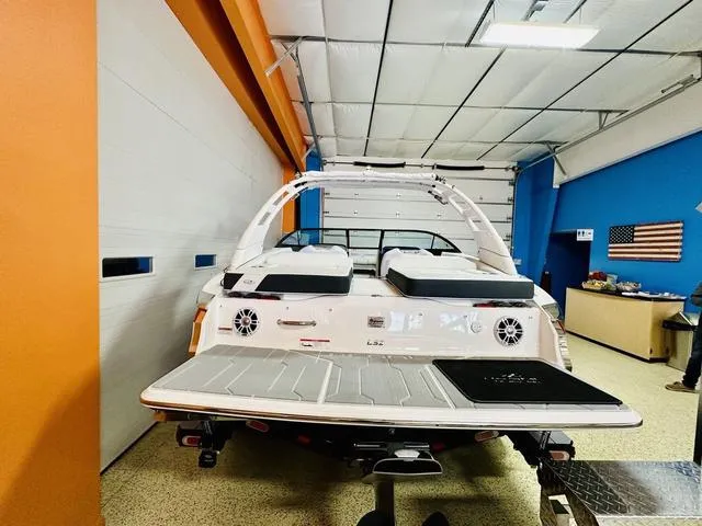 Slide: The Image of 2024 Regal LS2 boat in a garage with orange and blue walls. - 5
