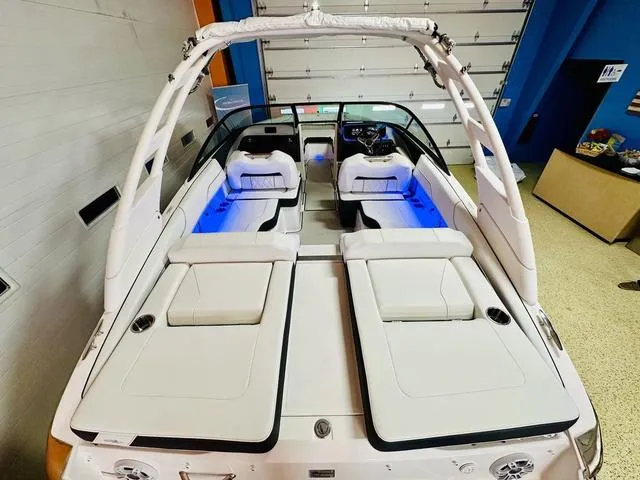 Slide: The Image of 2024 Regal LS2 boat interior with white seating and blue LED lighting. - 8