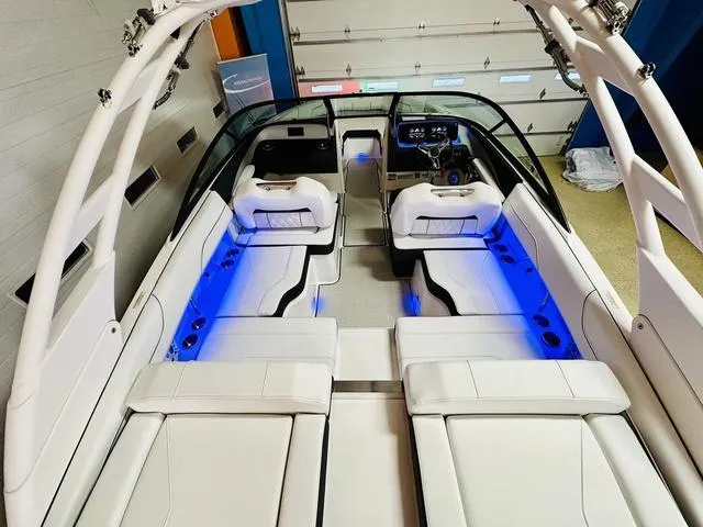 Slide: The Image of 2024 Regal LS2 boat interior with blue LED lighting and white seating. - 9