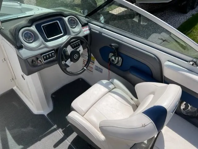 Slide: The Image of 2015 Chaparral 203VR boat cockpit with steering wheel and control panel. - 11