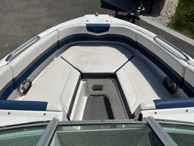 Slide: The Image of 2015 Chaparral 203VR boat interior with white and blue seating. - 13