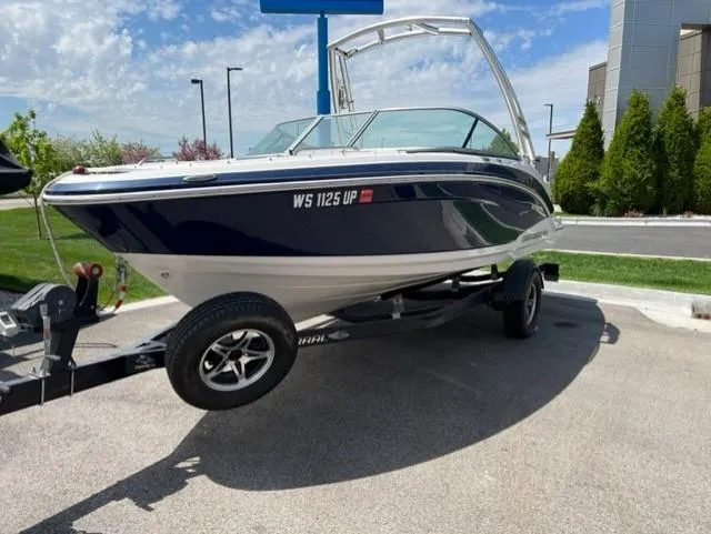 Slide: The Image of 2015 Chaparral 203VR boat on trailer, parked outdoors under a clear sky. - 3