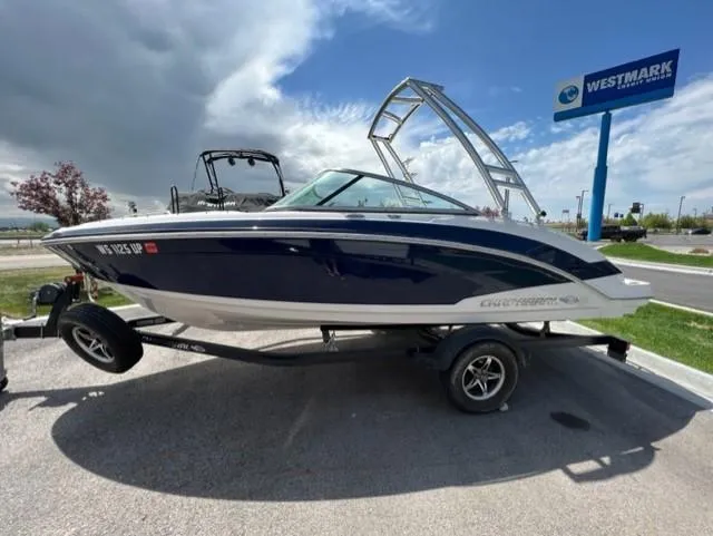 Slide: The Image of 2015 Chaparral 203VR boat on trailer, parked near Westmark sign under cloudy sky. - 4