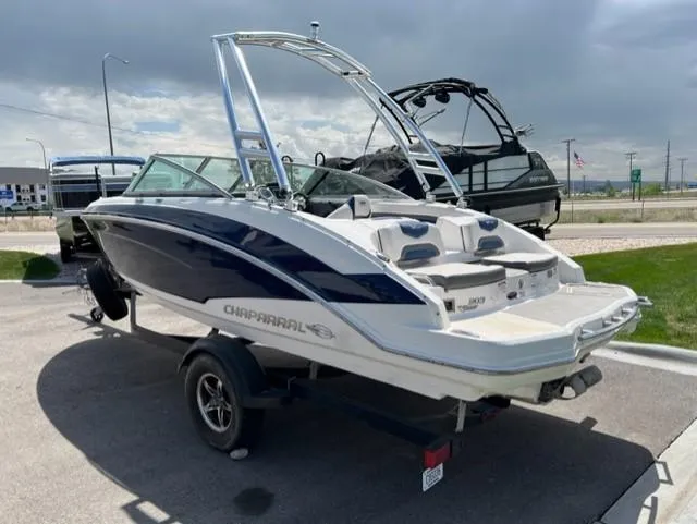Slide: The Image of 2015 Chaparral 203VR boat on trailer, parked outdoors under cloudy sky. - 5