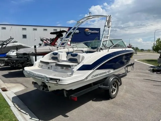 Slide: The Image of 2015 Chaparral 203VR boat on trailer, parked outdoors under a partly cloudy sky. - 7
