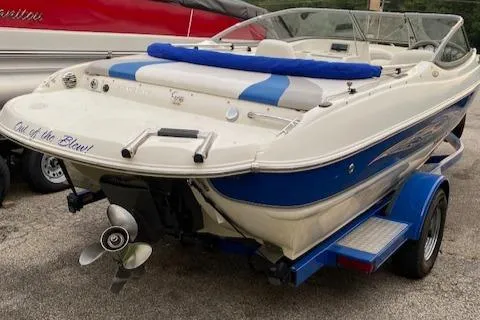 Slide: The Image of 2009 Stingray 195 LX boat on trailer, white and blue design, rear view. - 1