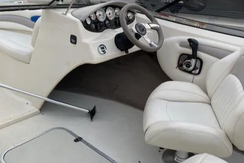 Slide: The Image of 2009 Stingray 195 LX boat interior with white seating and dashboard controls. - 2