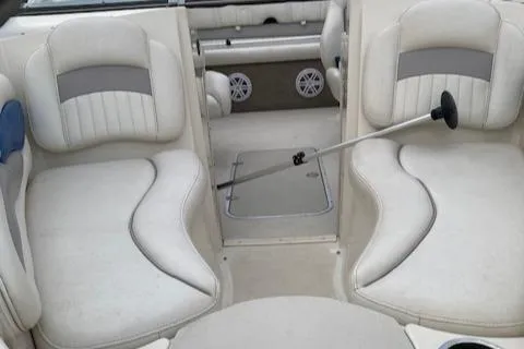 Slide: The Image of 2009 Stingray 195 LX boat interior with white seating and storage compartments. - 5