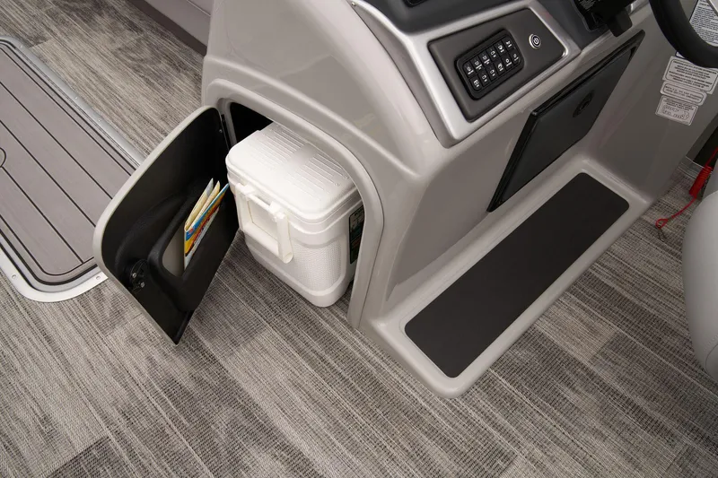 Slide: The Image of 2024 Ranger Reata 223C boat interior storage compartment with cooler and manuals. - 29