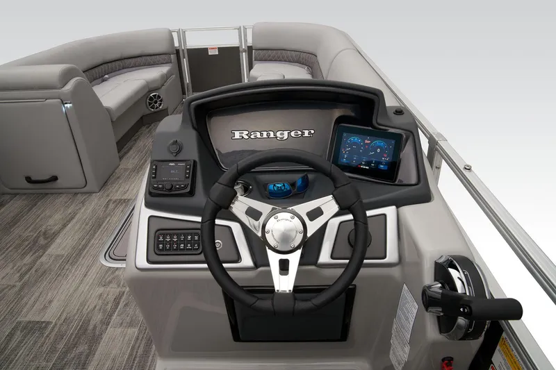 Slide: The Image of 2024 Ranger Reata 223C boat dashboard with steering wheel and digital display. - 34