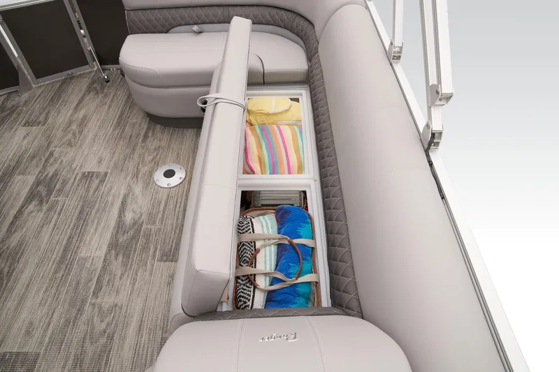 Slide: The Image of 2024 Ranger Reata 223C boat interior storage compartment with towels and bags. - 45