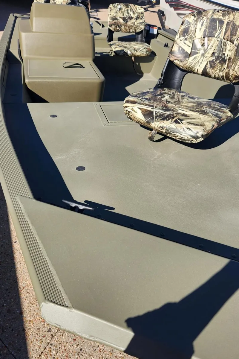 Slide: The Image of 2024 Tracker Grizzly 1754 SC boat with Mercury engine on a trailer. - 2