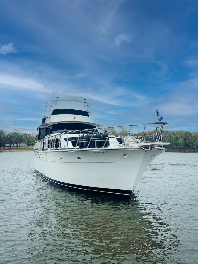 Slide: The Image of 1982 Bertram 58 Fly yacht on calm water under a blue sky. - 1