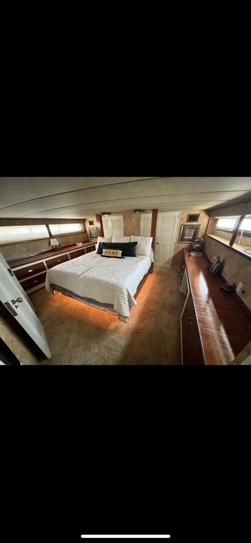 Slide: The Image of 1982 Bertram 58 Fly yacht bedroom with cozy bed and wooden interior. - 15