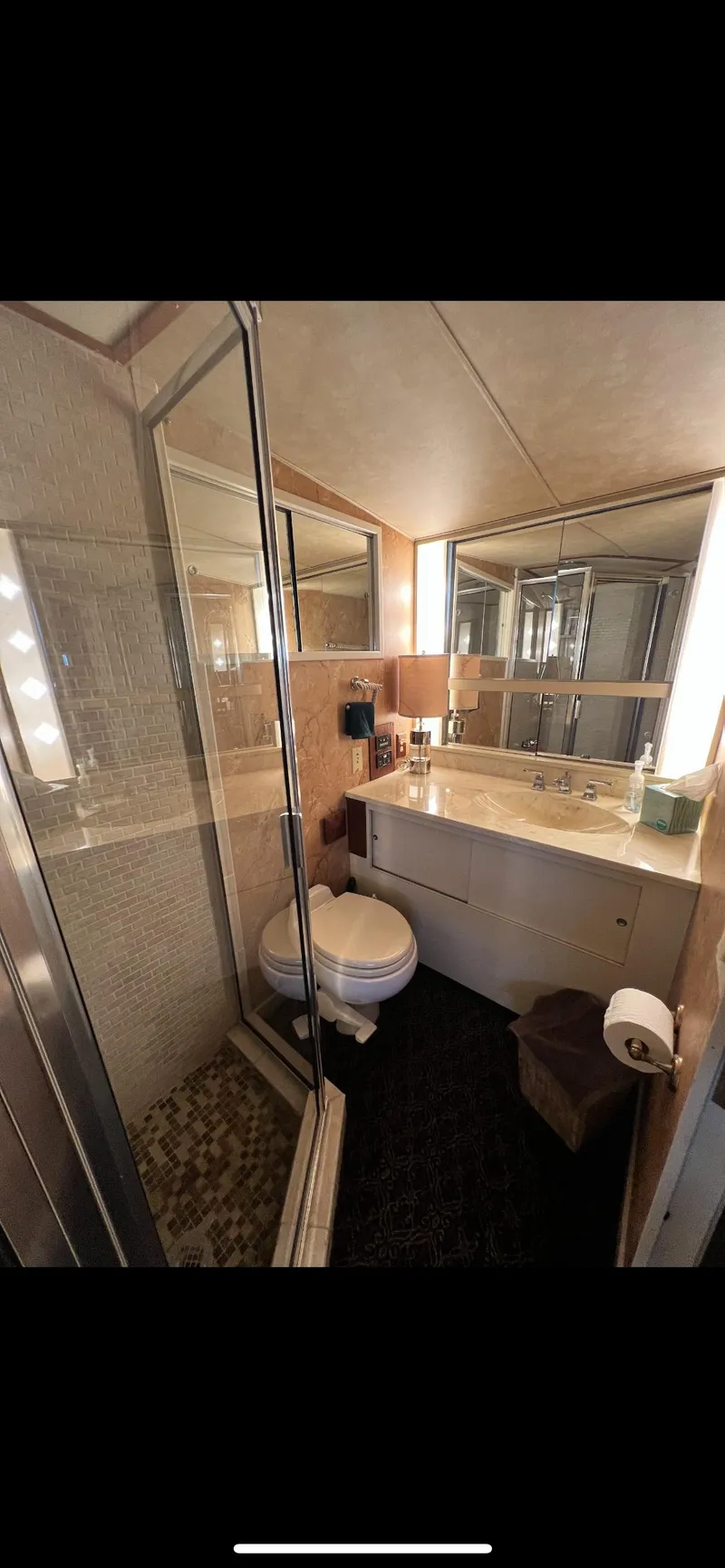Slide: The Image of Bathroom interior of 1982 Bertram 58 Fly yacht with shower, toilet, and sink. - 17
