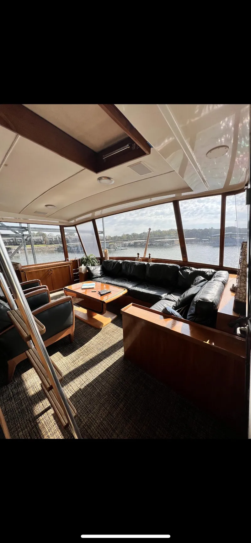 Slide: The Image of Interior of 1982 Bertram 58 Fly yacht with panoramic windows and leather seating. - 3