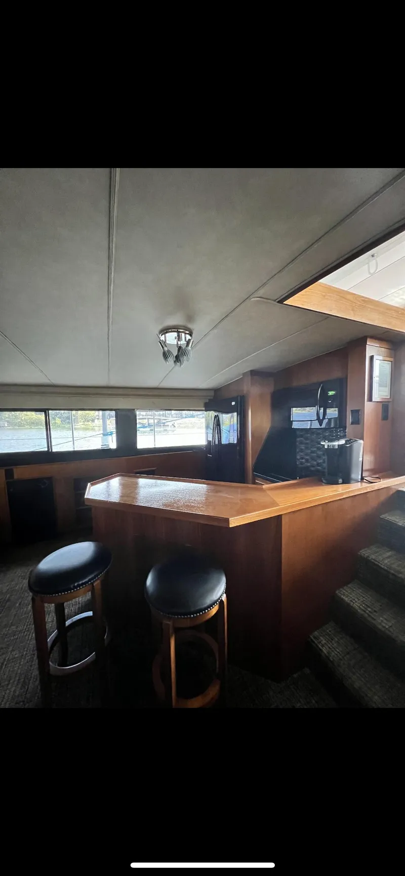 Slide: The Image of Interior of 1982 Bertram 58 Fly yacht with bar and stools. - 9