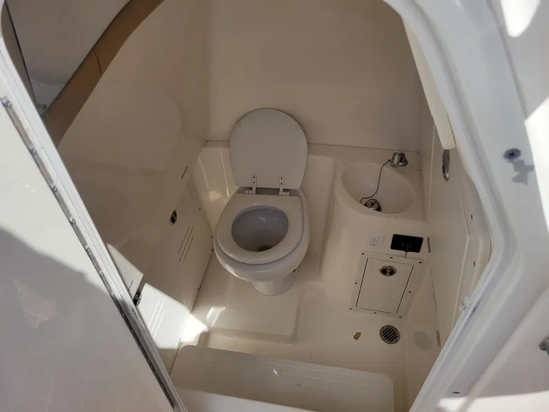 Slide: The Image of 2018 Key West 281 Billistic boat interior bathroom with toilet and sink. - 37