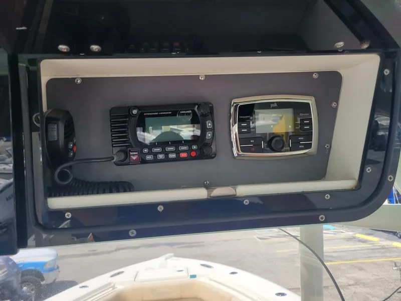 Slide: The Image of Control panel of a 2018 Key West 281 Billistic boat with radio and navigation systems. - 8