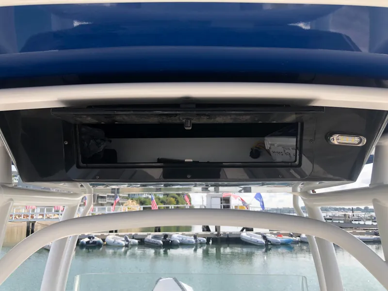 Slide: The Image of 2019 Wellcraft 242 Fisherman boat console with storage compartment, docked at marina. - 13