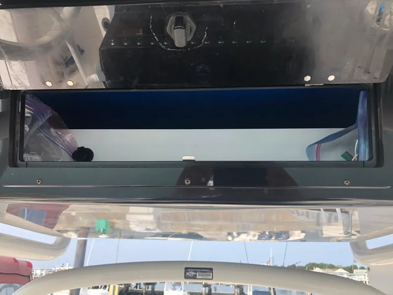 Slide: The Image of 2019 Wellcraft 242 Fisherman boat storage compartment, open with visible contents. - 14