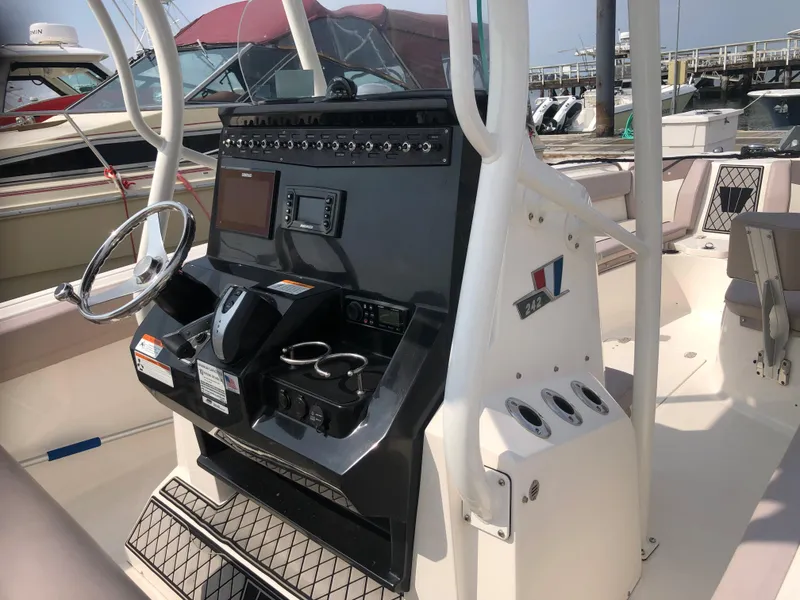 Slide: The Image of 2019 Wellcraft 242 Fisherman boat console with steering wheel and control panel. - 15
