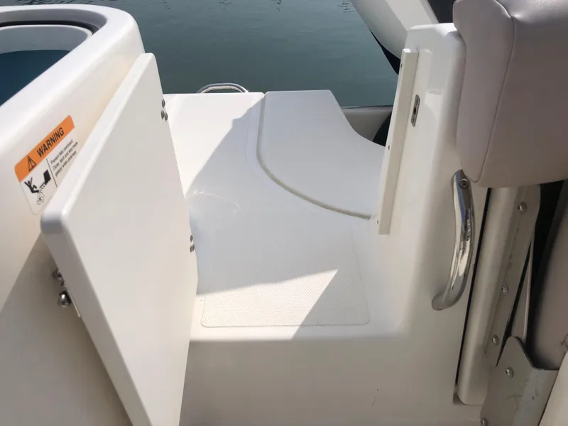 Slide: The Image of 2019 Wellcraft 242 Fisherman boat interior with open storage compartment and seating area. - 26