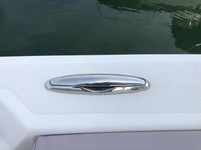 Slide: The Image of 2019 Wellcraft 242 Fisherman boat cleat on textured deck by water. - 27